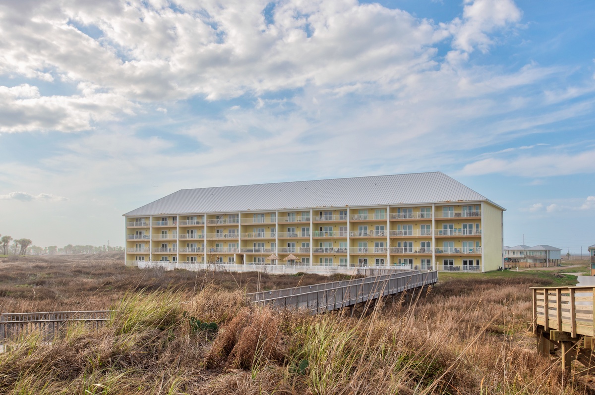 Beachfront property situated among coastal dunes with direct boardwalk access to the shoreline.
