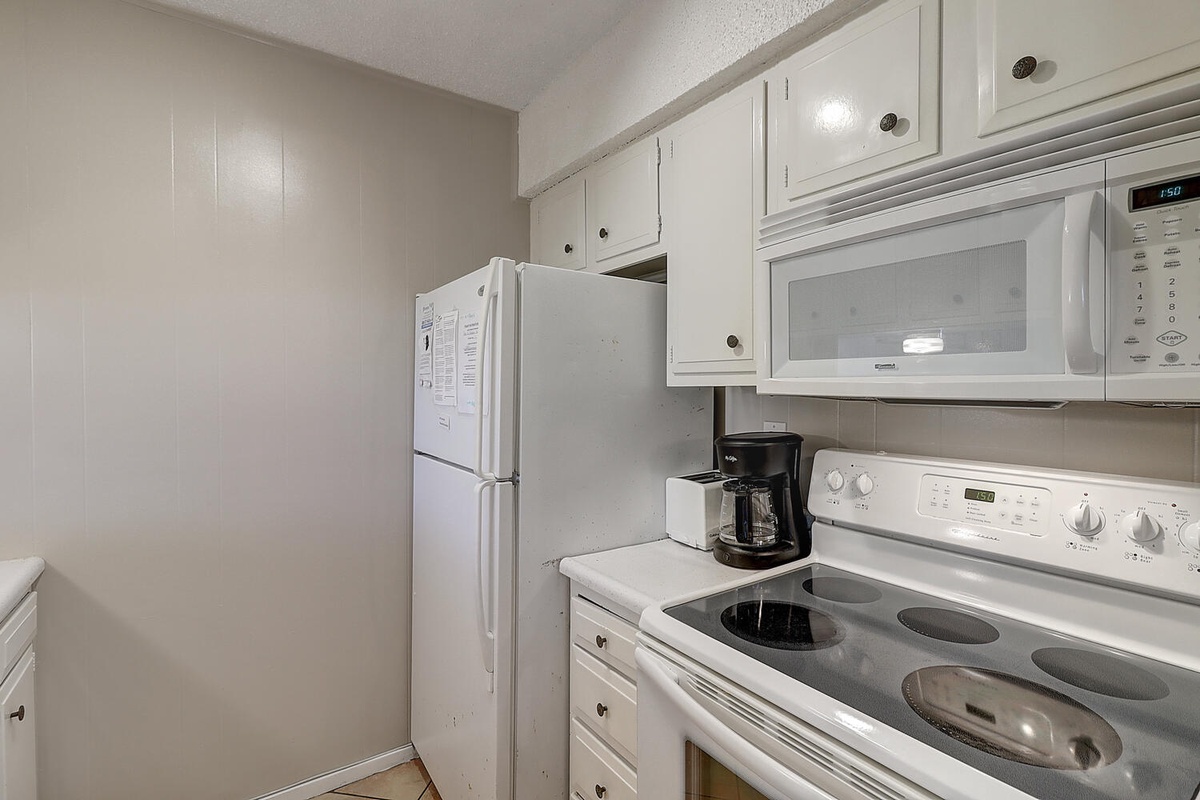 Cook your favorite meals in this fully equipped kitchen with modern appliances and ample storage space.