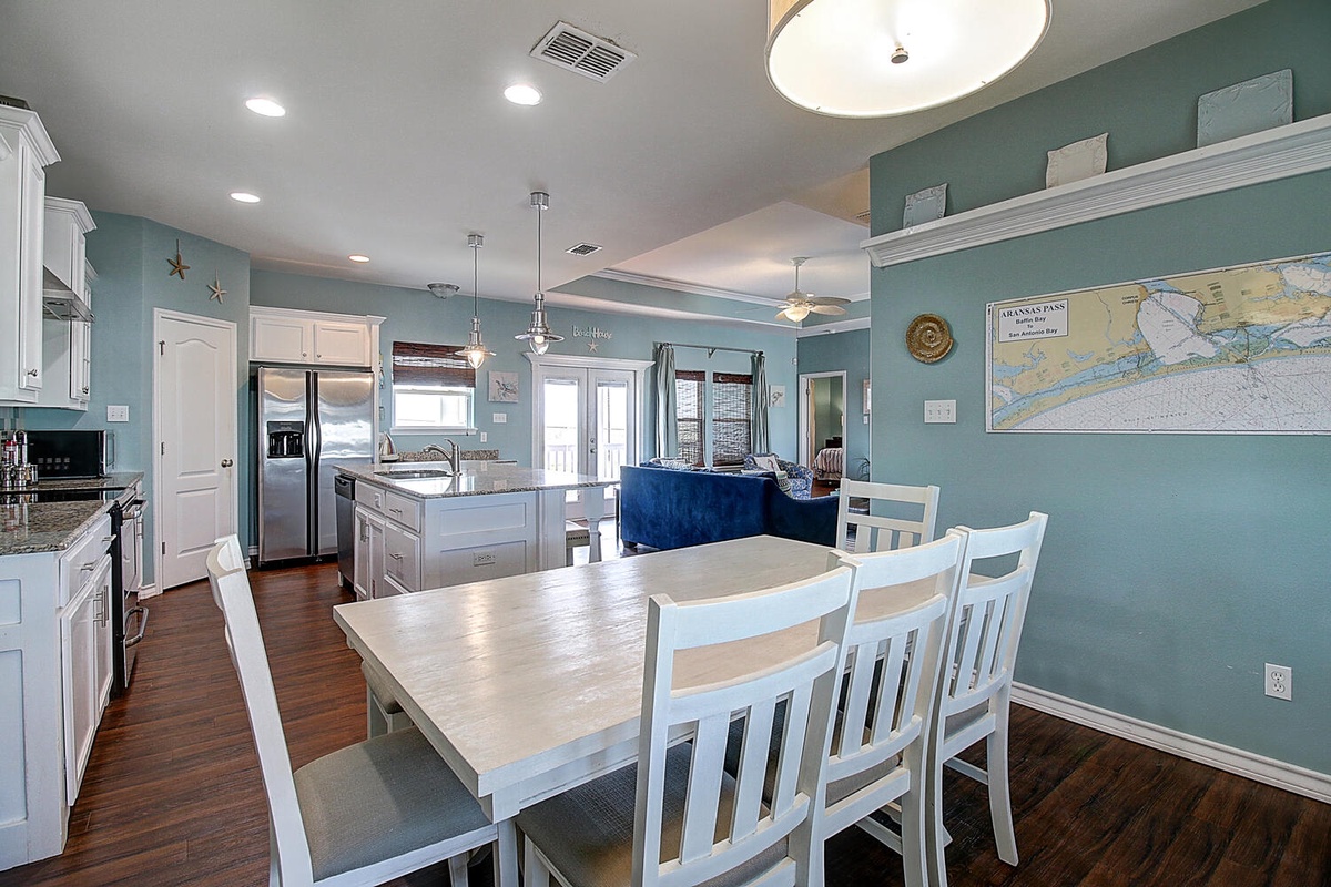 Your spacious open-plan kitchen and dining area features coastal-inspired décor, modern appliances, and comfortable seating for memorable family meals together.
