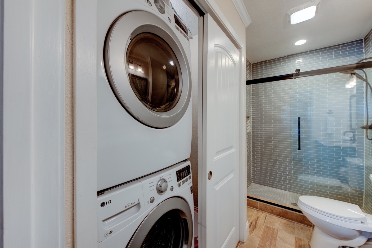 Keep your wardrobe fresh in your private laundry space, featuring full-size washer and dryer plus stylish subway tile shower.
