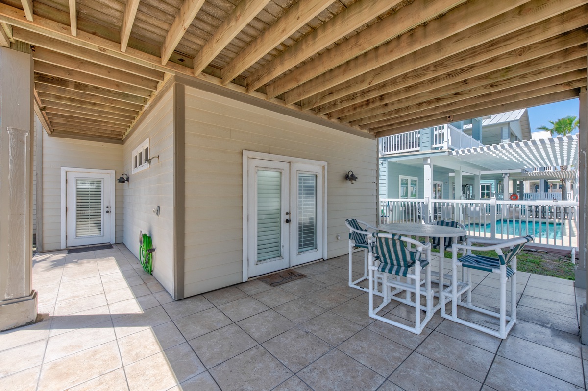 Your covered patio offers the perfect spot for poolside dining, with comfortable seating under beautiful exposed beams.
