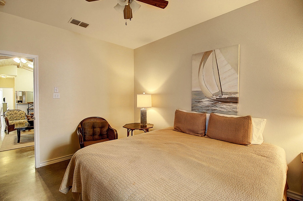 Sink into crisp linens and let the gentle ceiling fan breeze lull you to peaceful sleep in your private coastal retreat.