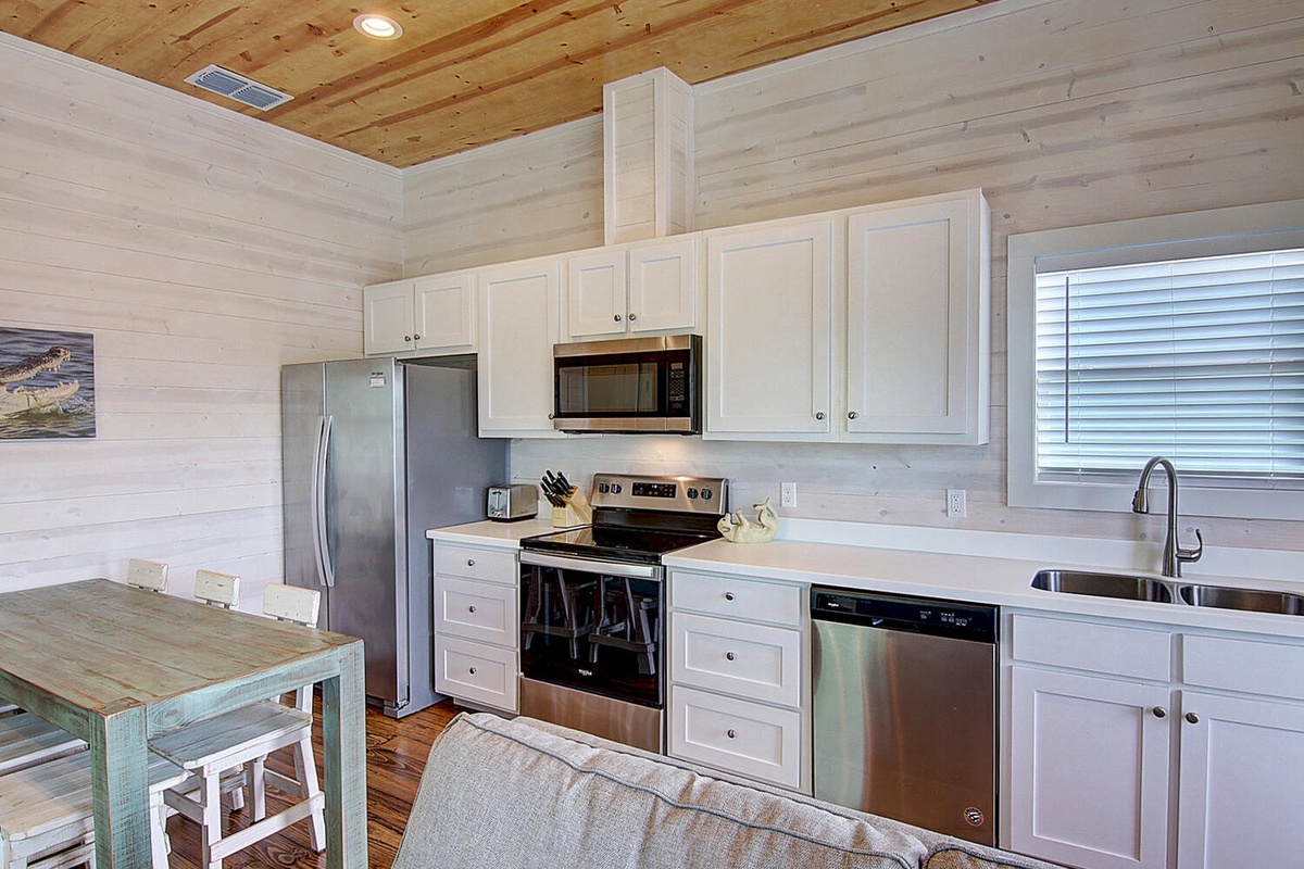 Your fully equipped kitchen features modern appliances and warm wood accents, perfect for preparing meals during your stay.