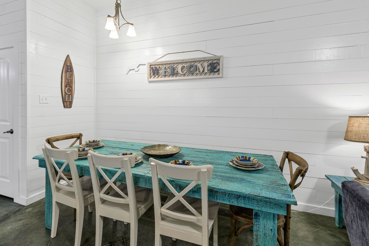 You'll love gathering around this charming turquoise farmhouse table, where coastal vibes meet comfort in your bright dining space.