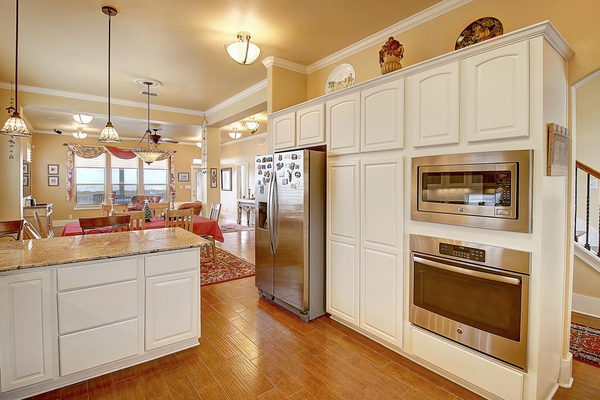 Your gourmet kitchen awaits with stainless steel appliances, granite counters, and elegant white cabinetry—perfect for creating memorable meals together.