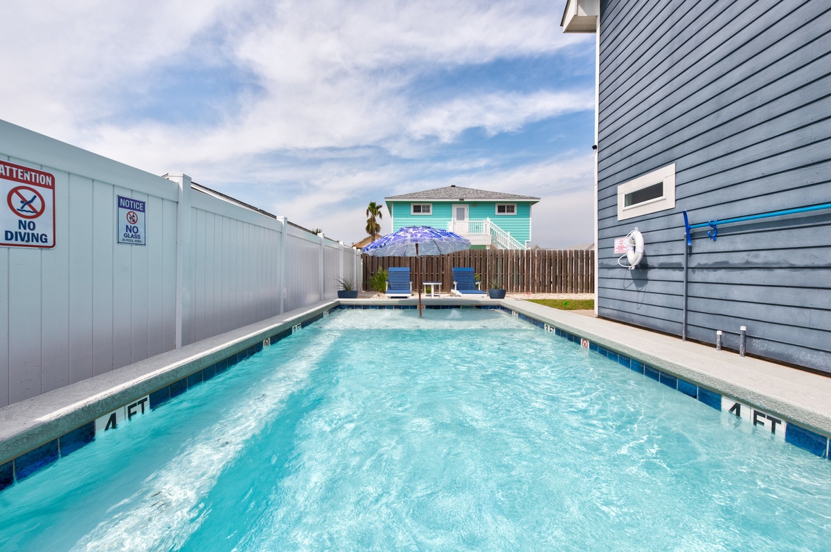 Dive into your own private oasis with crystal-clear waters surrounded by colorful beach houses and swaying palms.