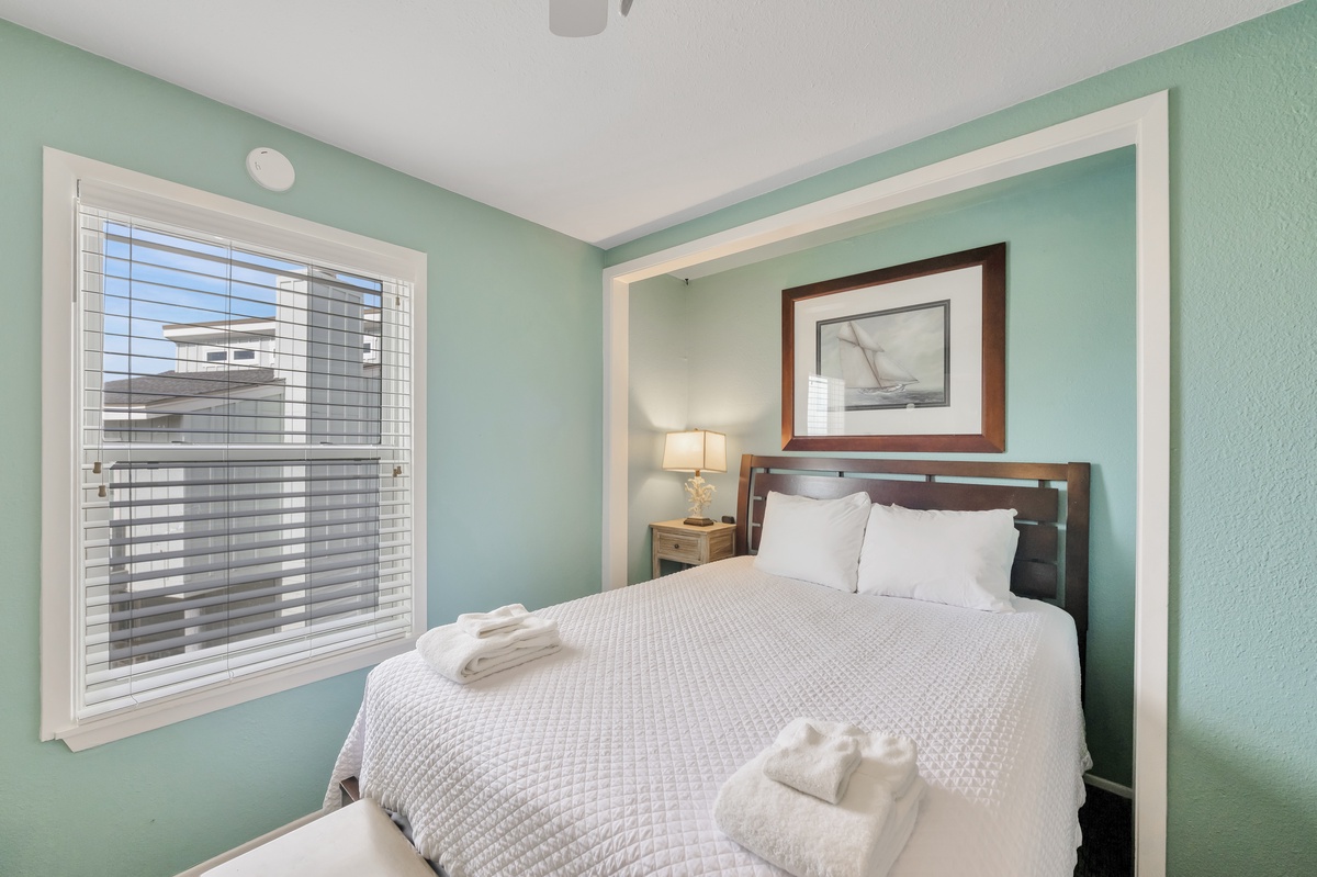 Rest peacefully in your serene bedroom with soft mint walls and crisp white linens that invite sweet dreams after your day of exploring.