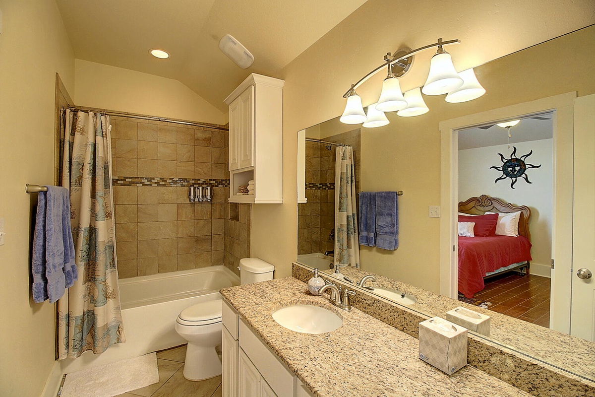 Unwind in your spacious bathroom with granite counters, soaking tub, and elegant lighting that creates the perfect ambiance for relaxation.