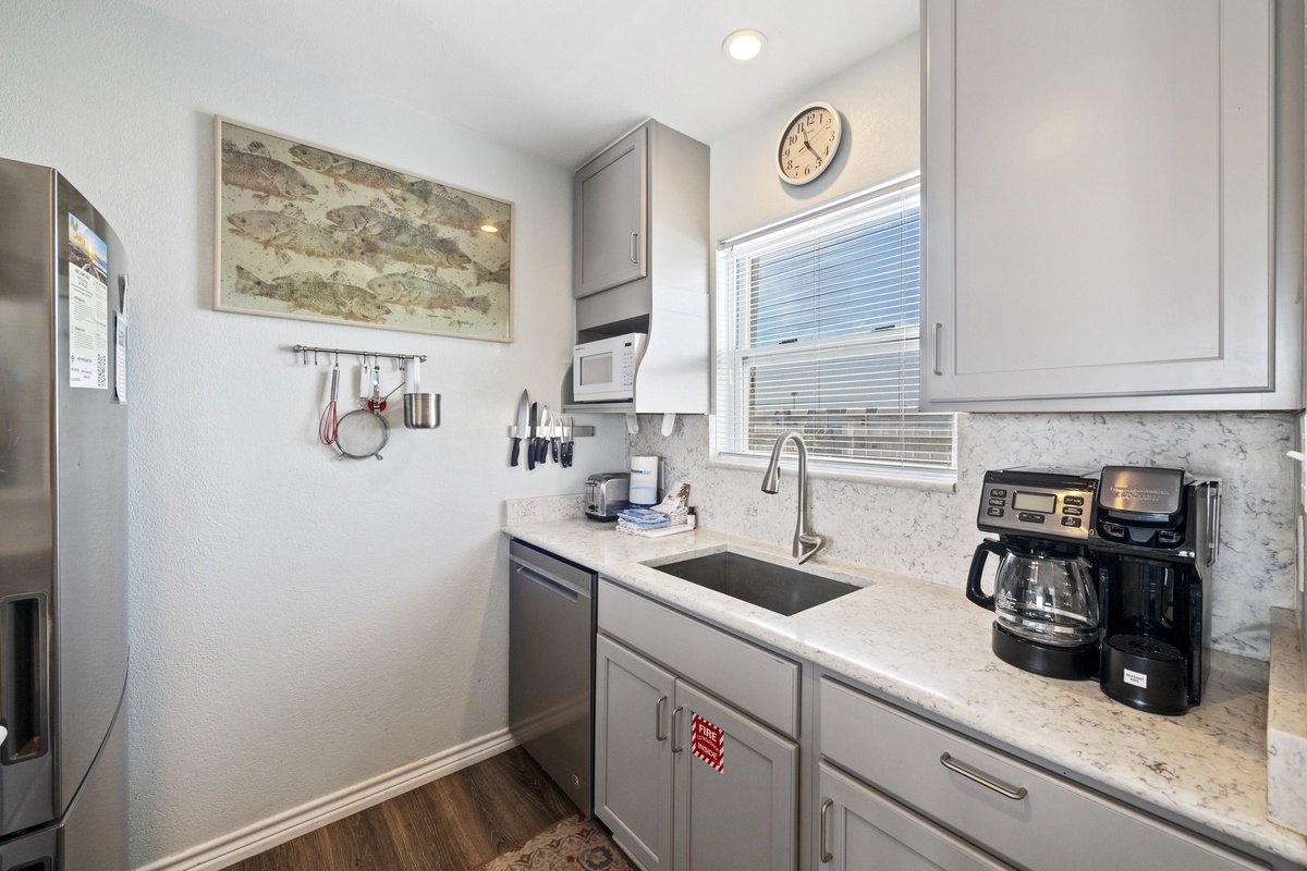Your modern kitchen awaits with marble countertops, stainless appliances, and coffee maker for perfect morning brews.