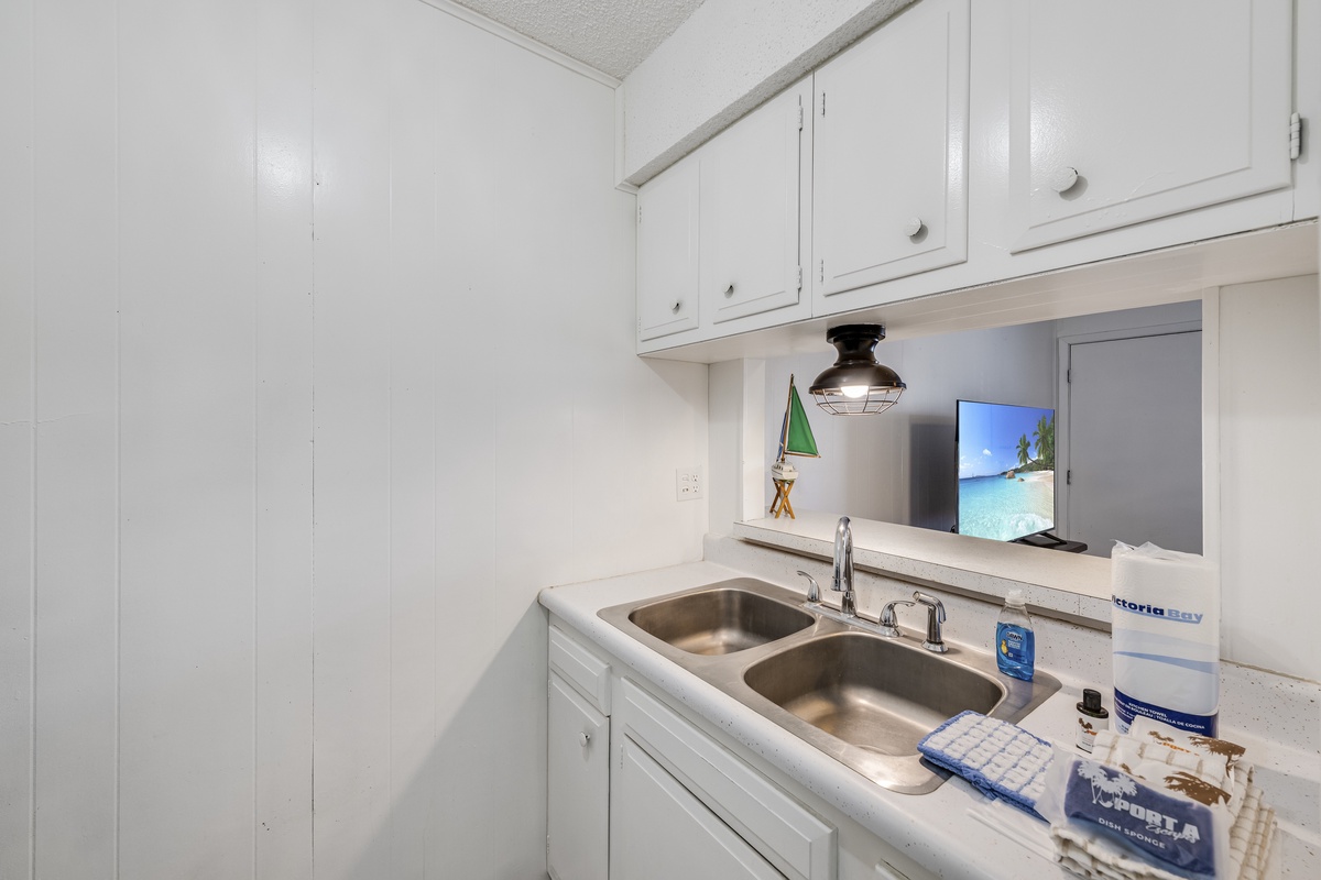 Your bright kitchenette features everything you need for easy meal prep with modern appliances and coastal charm.