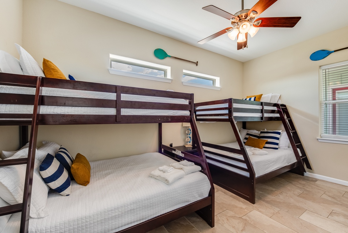 Your family will love this cheerful bunk room with comfy beds and playful decor—perfect for kids' adventures and sweet dreams.