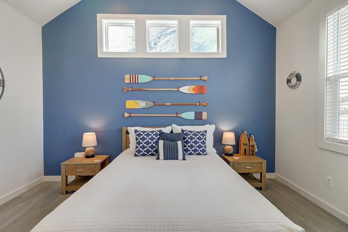 Drift off to sleep surrounded by coastal charm—your nautical-themed bedroom features crisp white linens and ocean-inspired decor.