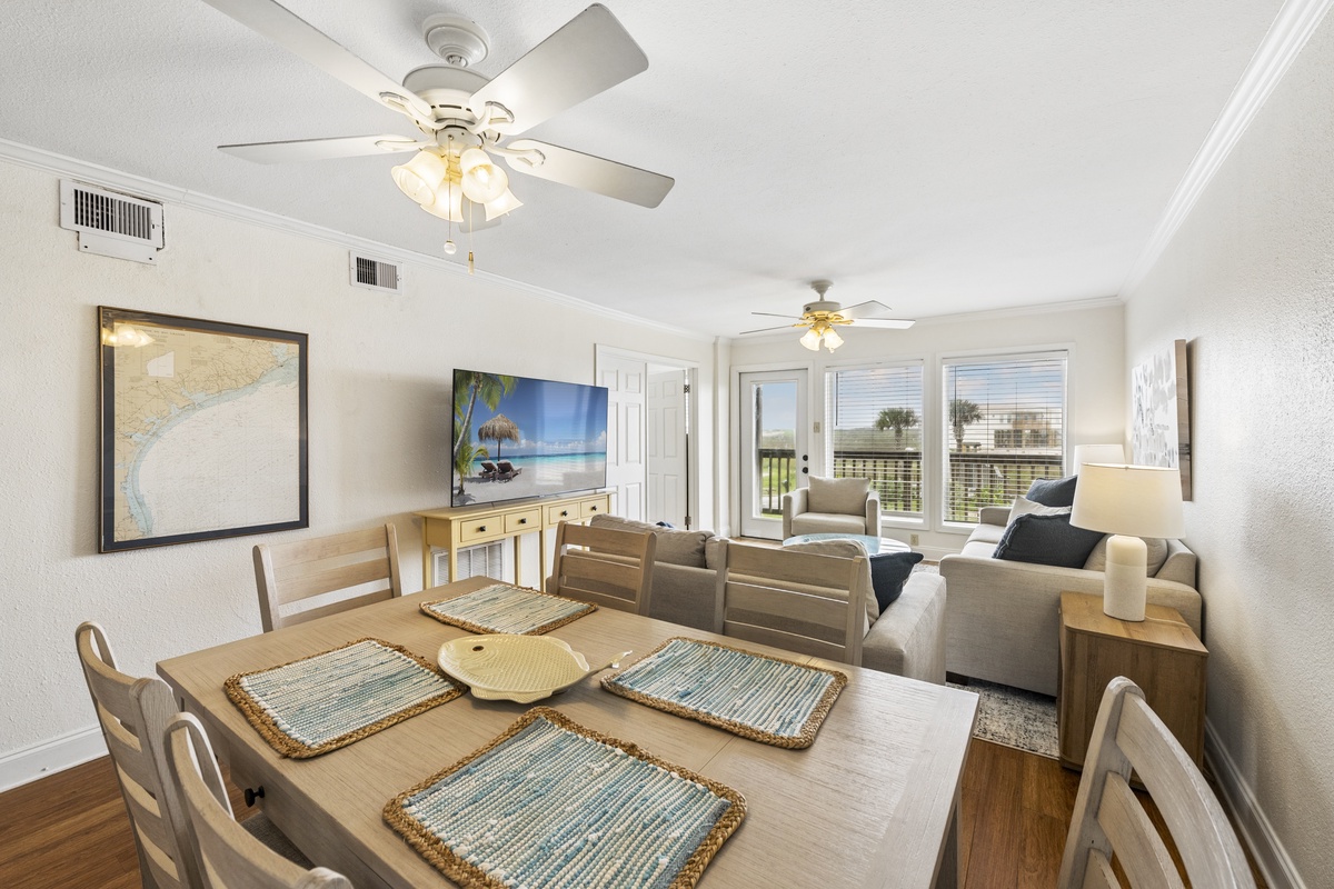 Unwind in your bright, open living space where coastal style meets comfort—ceiling fans keep you cool while you relax or gather around the dining table with loved ones.