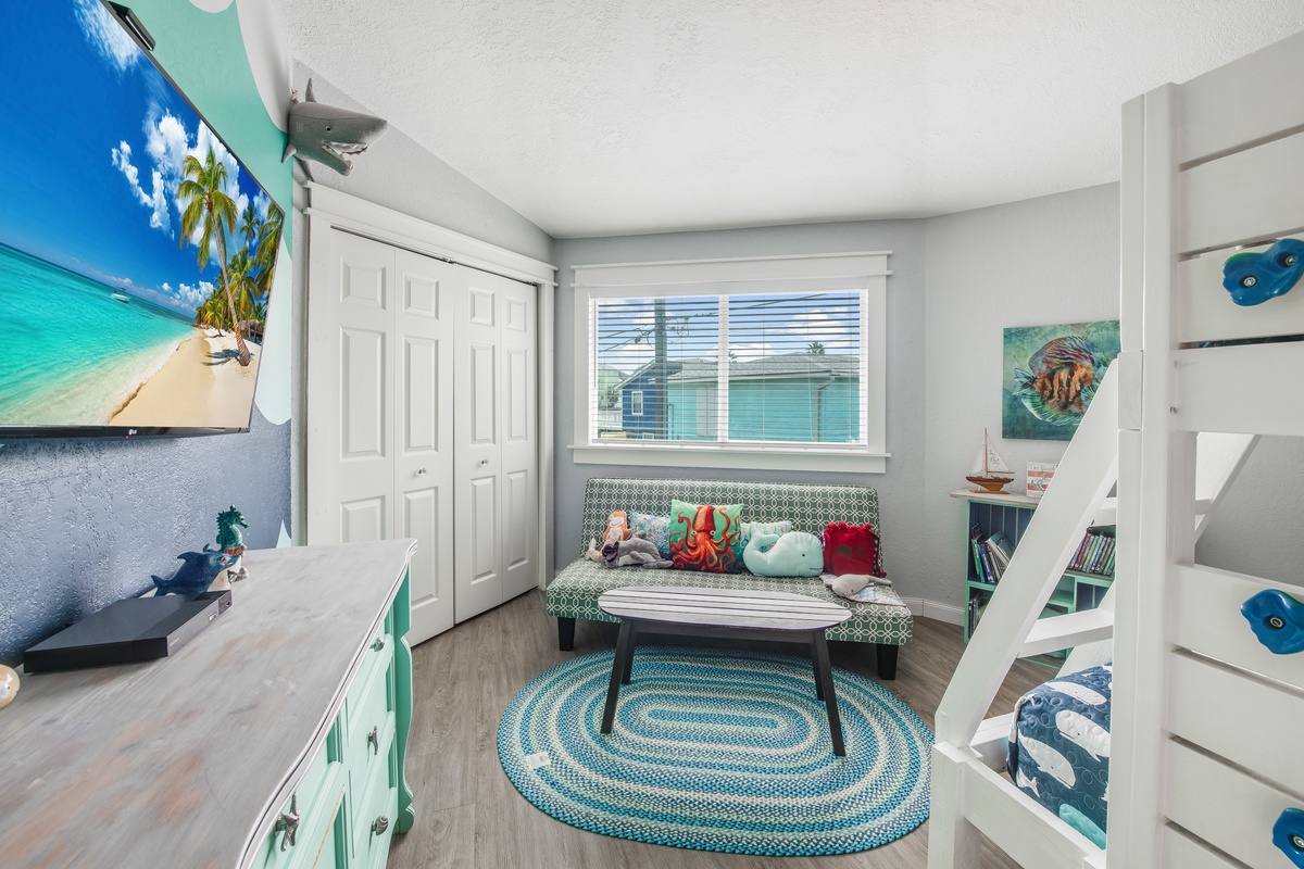 Your kids will love this ocean-themed playroom with tropical TV, cozy reading nook, and fun bunk beds for magical sleepovers.
