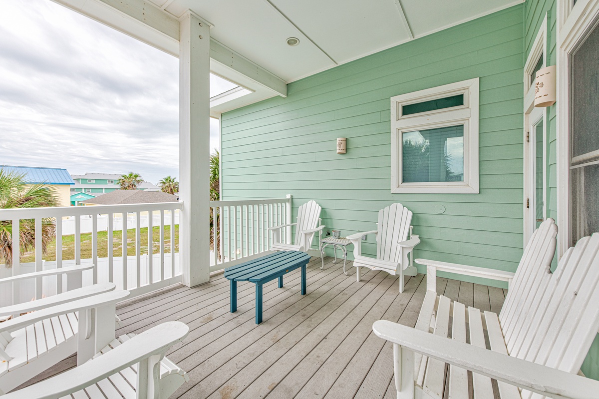 Unwind in your private coastal retreat with comfortable Adirondack chairs and ocean breezes on this charming covered deck.
