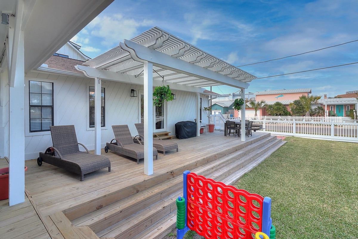 Relax on your private deck with loungers while the kids play in the yard—perfect family vacation retreat.