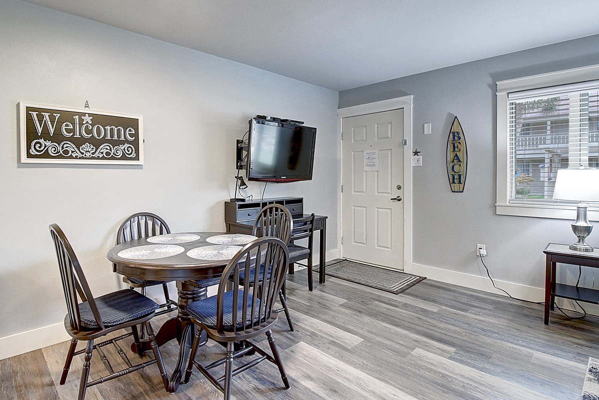 Gather around this charming dining table for meals with loved ones, while enjoying the flat-screen TV nearby.