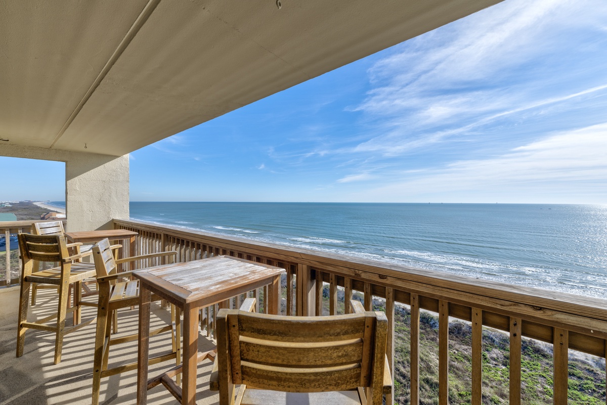 Sip your morning coffee at this oceanfront table while endless waves roll beneath your private balcony paradise.