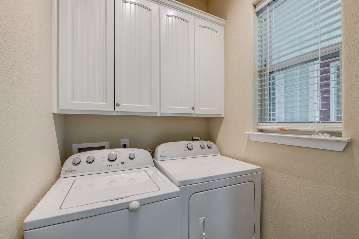 Keep your wardrobe fresh in this convenient laundry room, complete with full-size washer and dryer plus storage cabinets for all your needs.