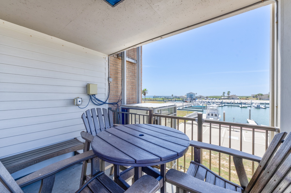 Sip your morning coffee at your private waterfront table while watching boats drift peacefully through the marina.