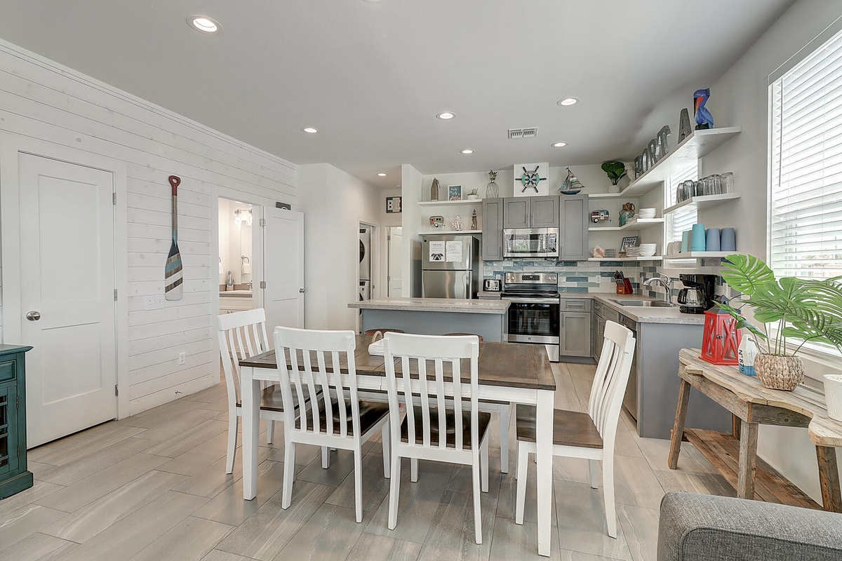 Your coastal-themed kitchen flows seamlessly into a bright dining area where you'll enjoy meals with loved ones.