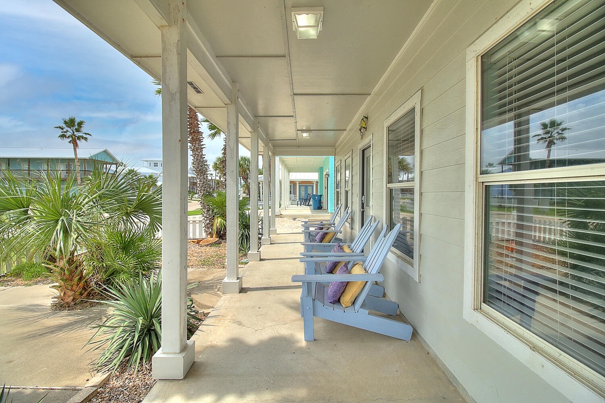 Relax in your own Adirondack chair on this peaceful covered porch, where tropical breezes and palm views create the perfect morning coffee spot.