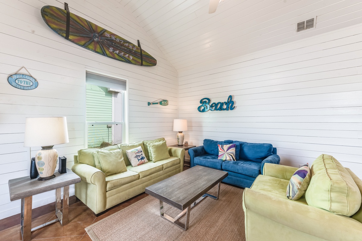 Unwind in your coastal-themed living space with comfy sofas and beach-inspired decor that sets the perfect relaxed vacation mood.