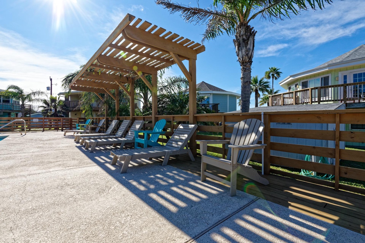 Soak up the tropical sun on your private deck with comfortable lounge chairs and shade pergola, surrounded by swaying palms.