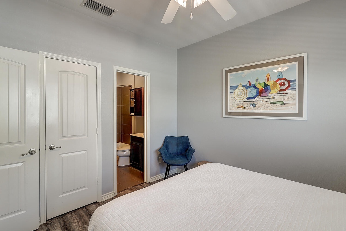 Relax in your comfortable bedroom featuring crisp linens, a cozy reading chair, and an ensuite bathroom for convenience.