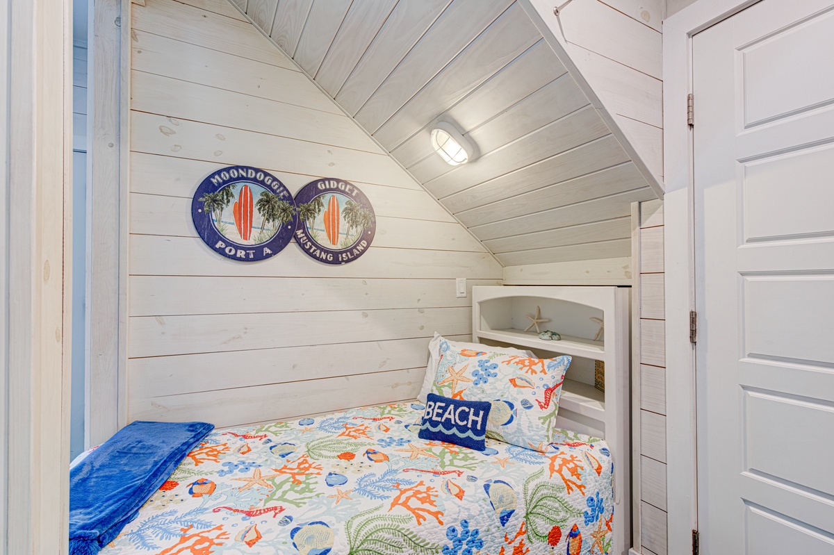 Your cozy beach-themed nook awaits with charming coastal decor and built-in sleeping alcove for a peaceful retreat.