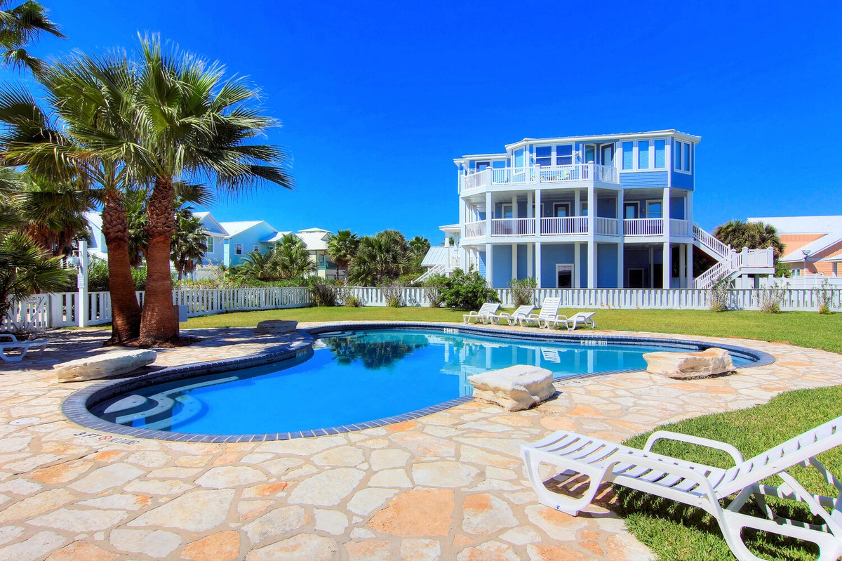 Dive into paradise! Your private pool oasis awaits with crystal-clear waters, tropical palms, and lounging space under endless blue skies.