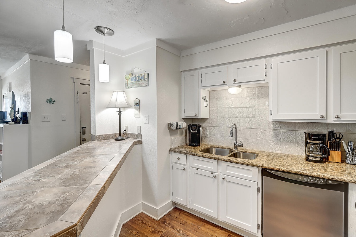 Your bright kitchen awaits with granite counters, modern appliances, and everything you need for memorable meals together.