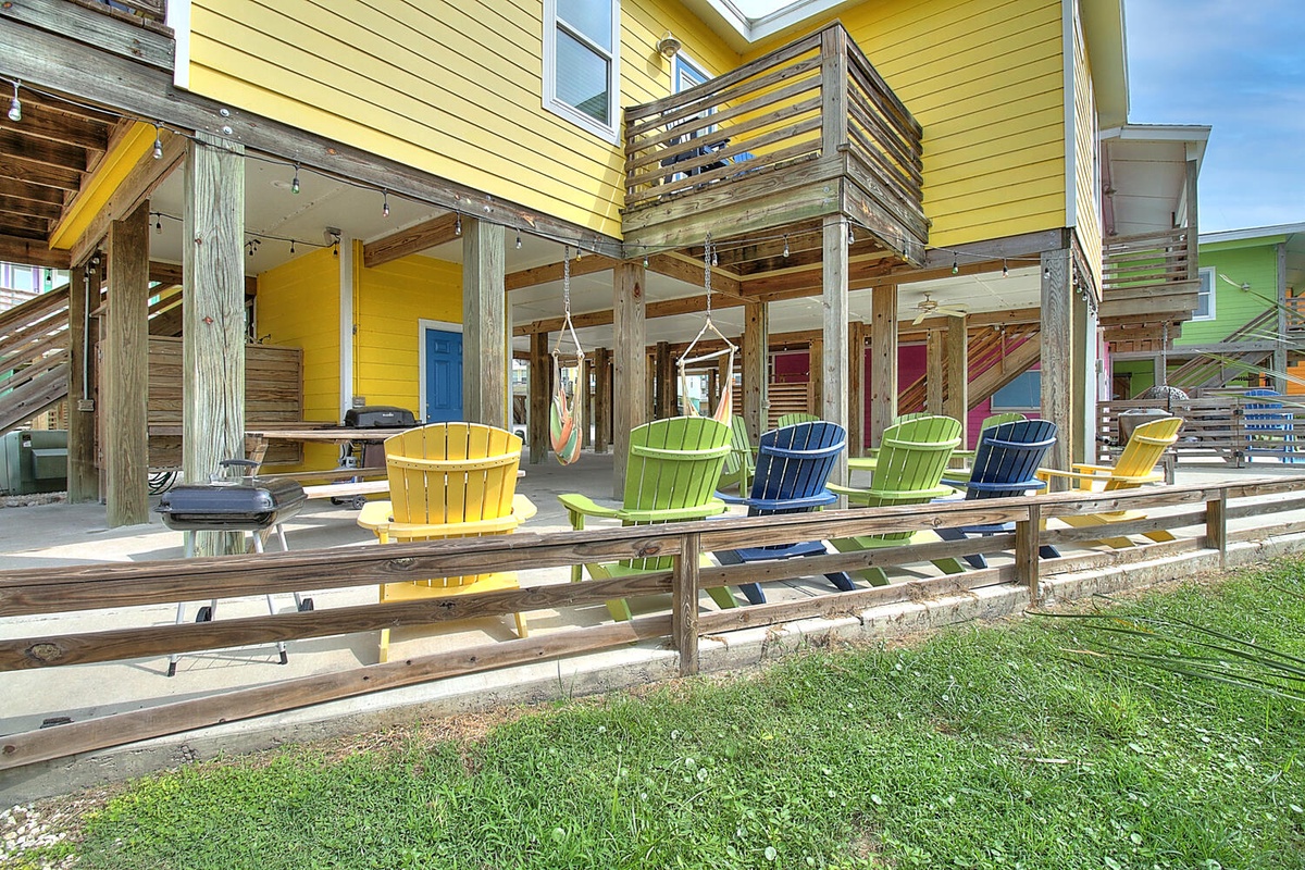 Colorful beach cottages featuring vibrant Adirondack chairs and hammocks on covered porches for relaxing coastal getaways.