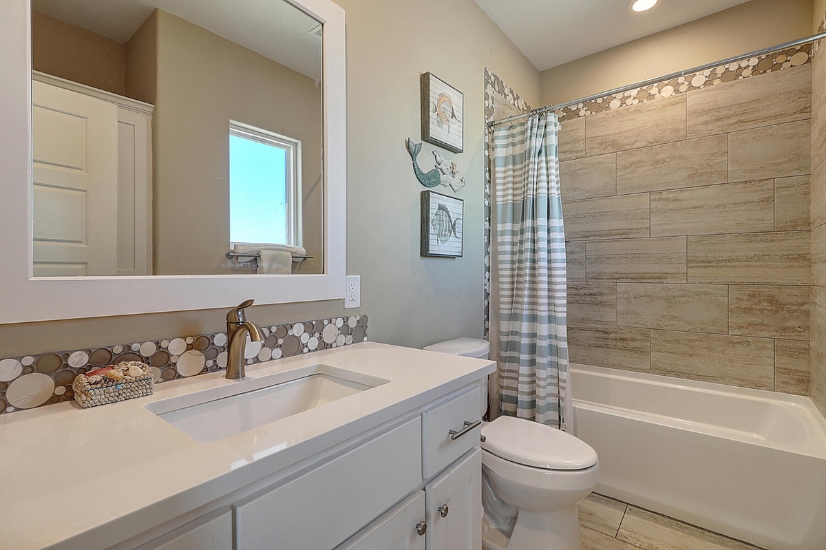 Step into your private bathroom with beautiful tile accents, modern fixtures, and everything you need for a refreshing start to your day.