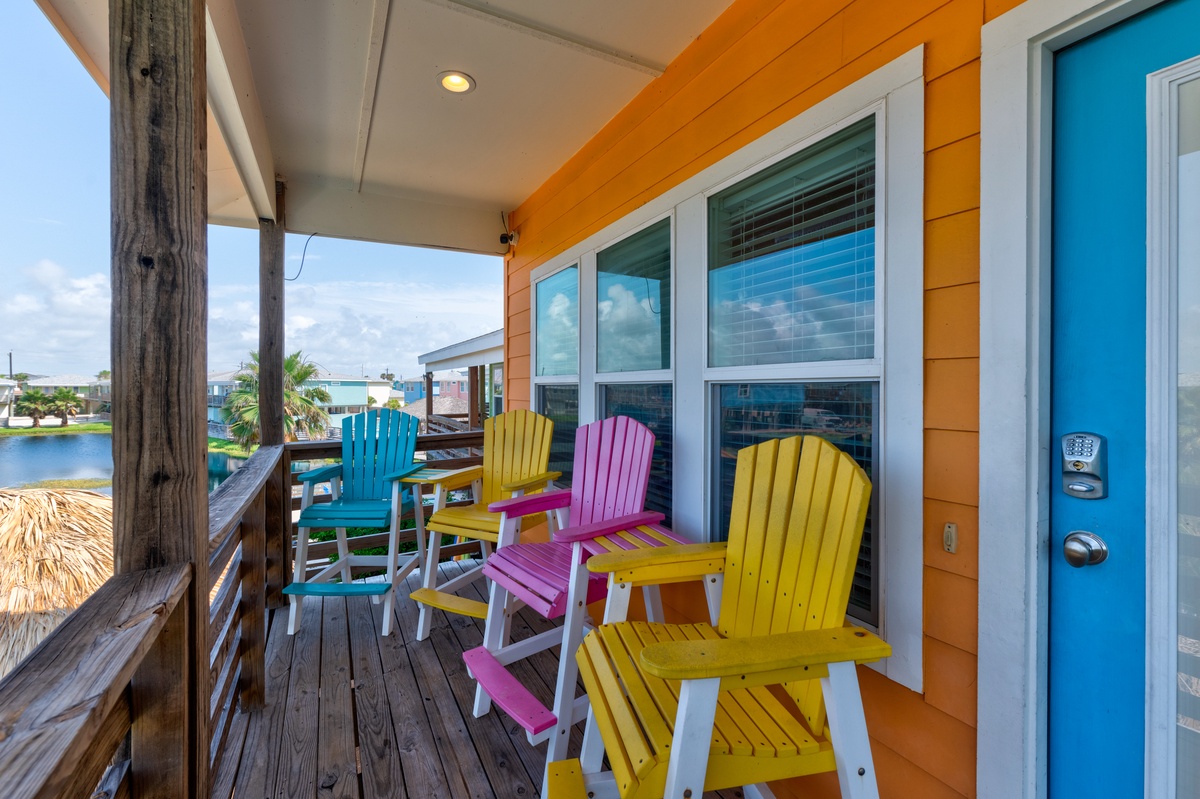 Step onto your private covered deck with vibrant Adirondack chairs and watch boats drift by on peaceful waters.