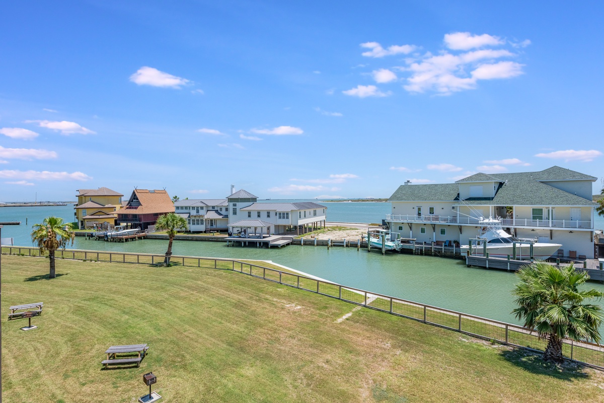 Waterfront community with canal access, private docks, and charming coastal homes under sunny skies.