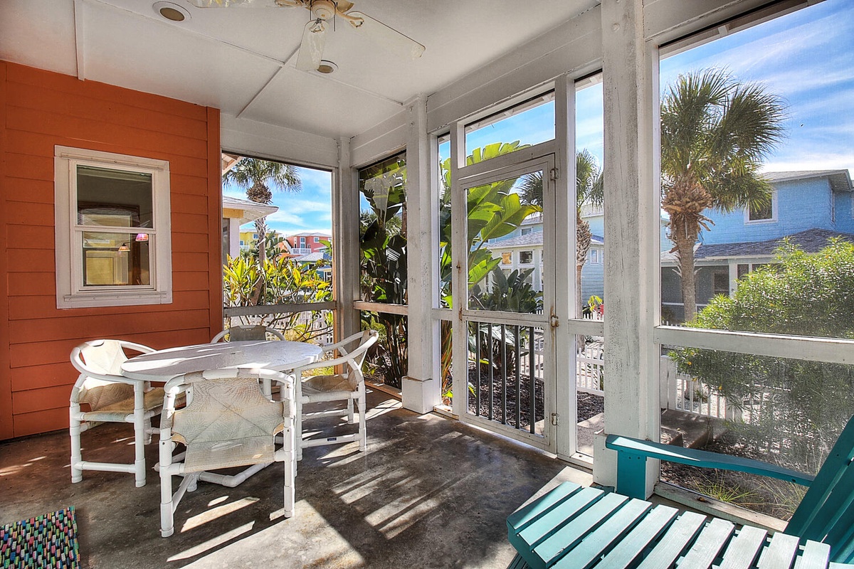 Your bright screened porch invites morning coffee and sunset relaxation, surrounded by lush tropical palms and colorful coastal views.