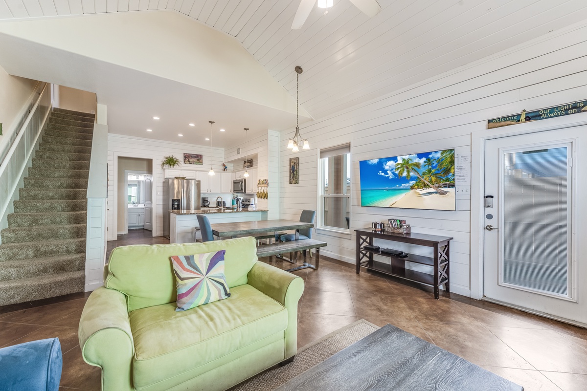 Unwind in this bright open-concept space where coastal charm meets modern comfort, featuring vaulted ceilings and tropical touches throughout.
