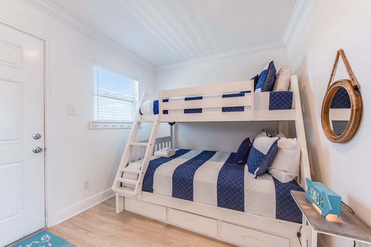 Stylish bunk beds with nautical bedding create the perfect kids' retreat, complete with storage and coastal charm for your little ones.