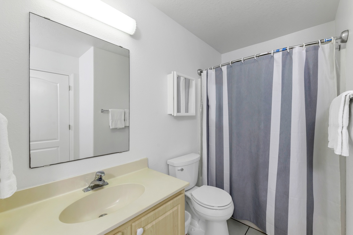 Freshen up in your private bathroom with a spacious shower, vanity, and all essentials for a comfortable stay.