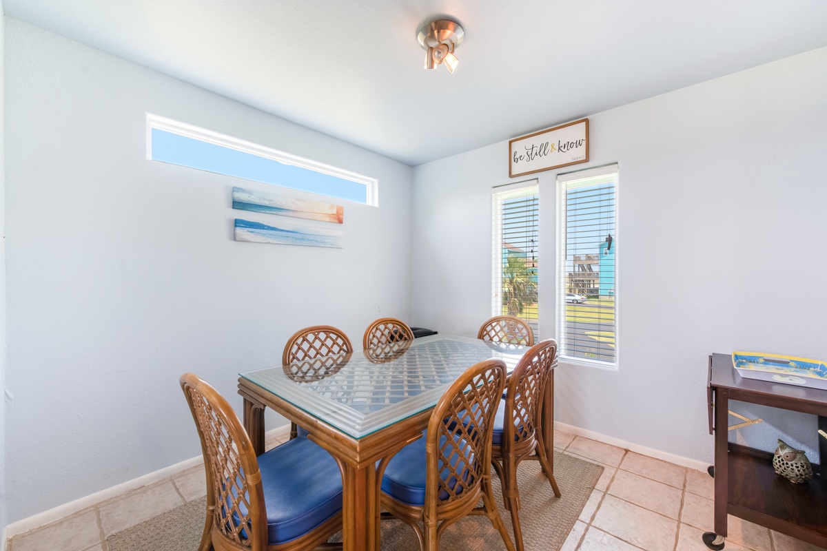 Gather around your bright dining space with comfortable seating for six, where natural light streams through large windows as you plan your day.
