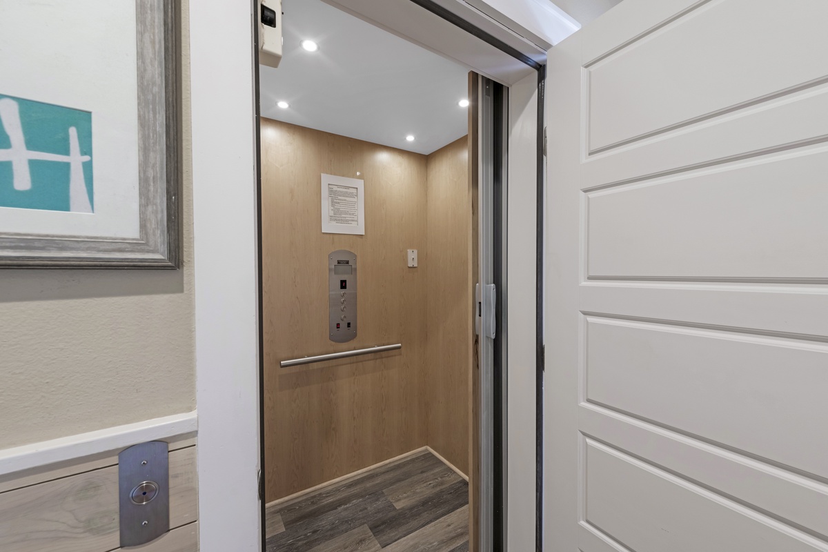 Step into your private elevator for effortless access to your spacious retreat, featuring elegant wood paneling and modern conveniences.