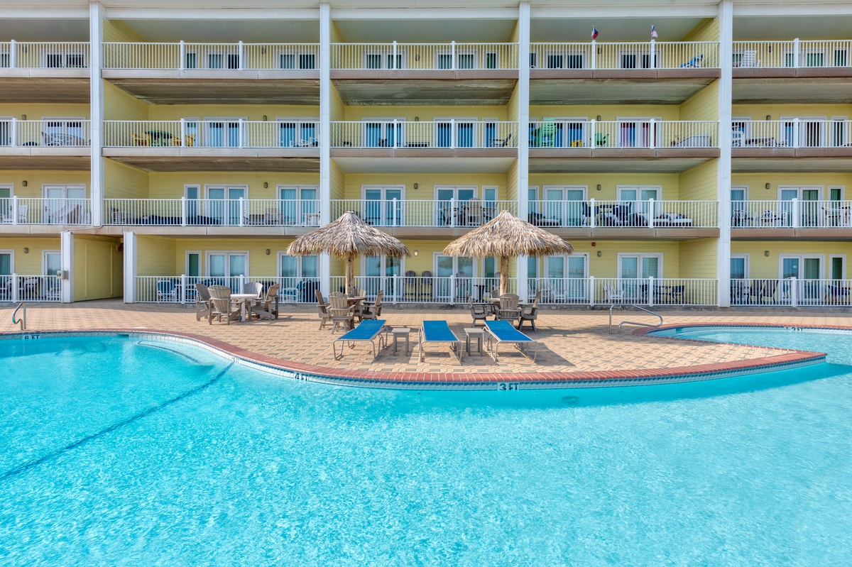 Dive into crystal-clear waters surrounded by tropical thatched umbrellas and comfortable loungers—your perfect poolside paradise awaits.