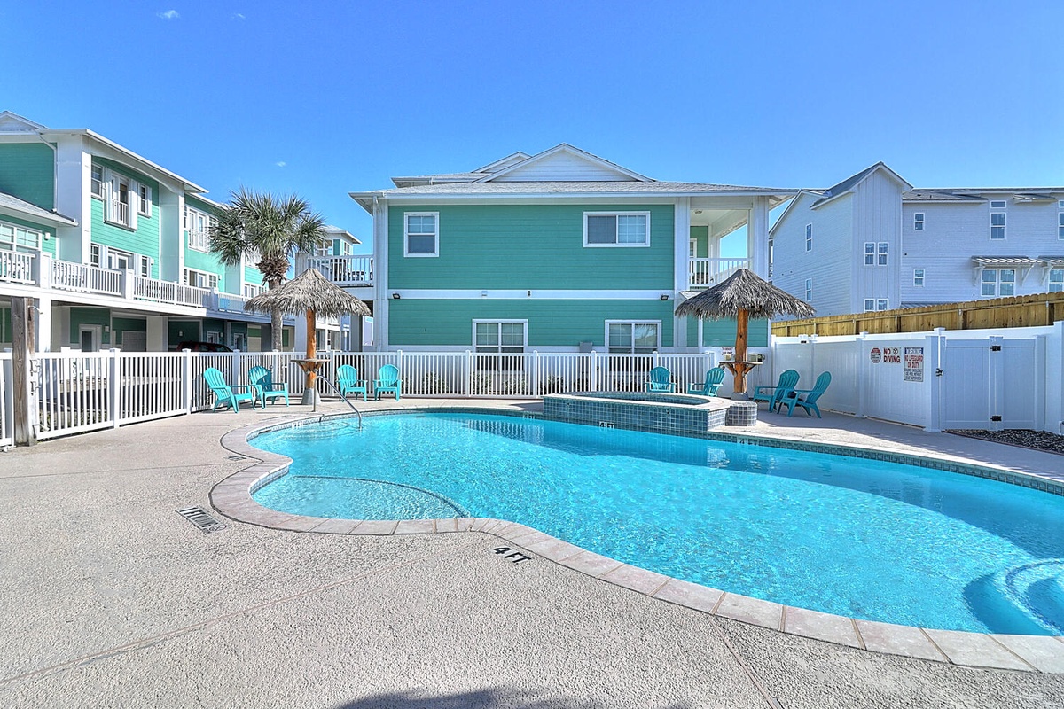 Dive into crystal-clear waters while tropical palms sway overhead, creating your perfect poolside paradise.