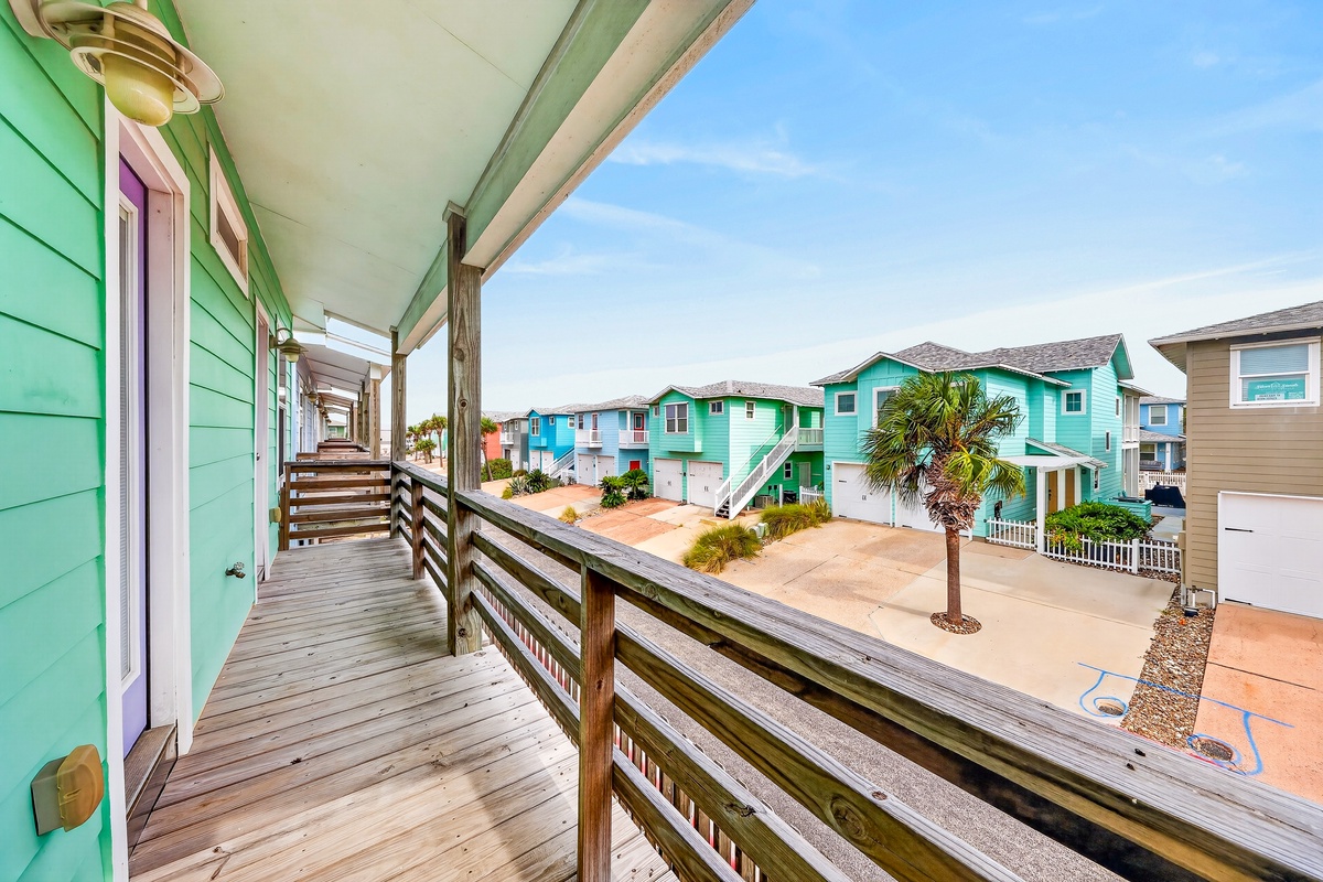 A welcoming coastal neighborhood framed by vibrant beach houses and swaying palms. This sunny, colorful community sets the scene for a perfect seaside getaway.