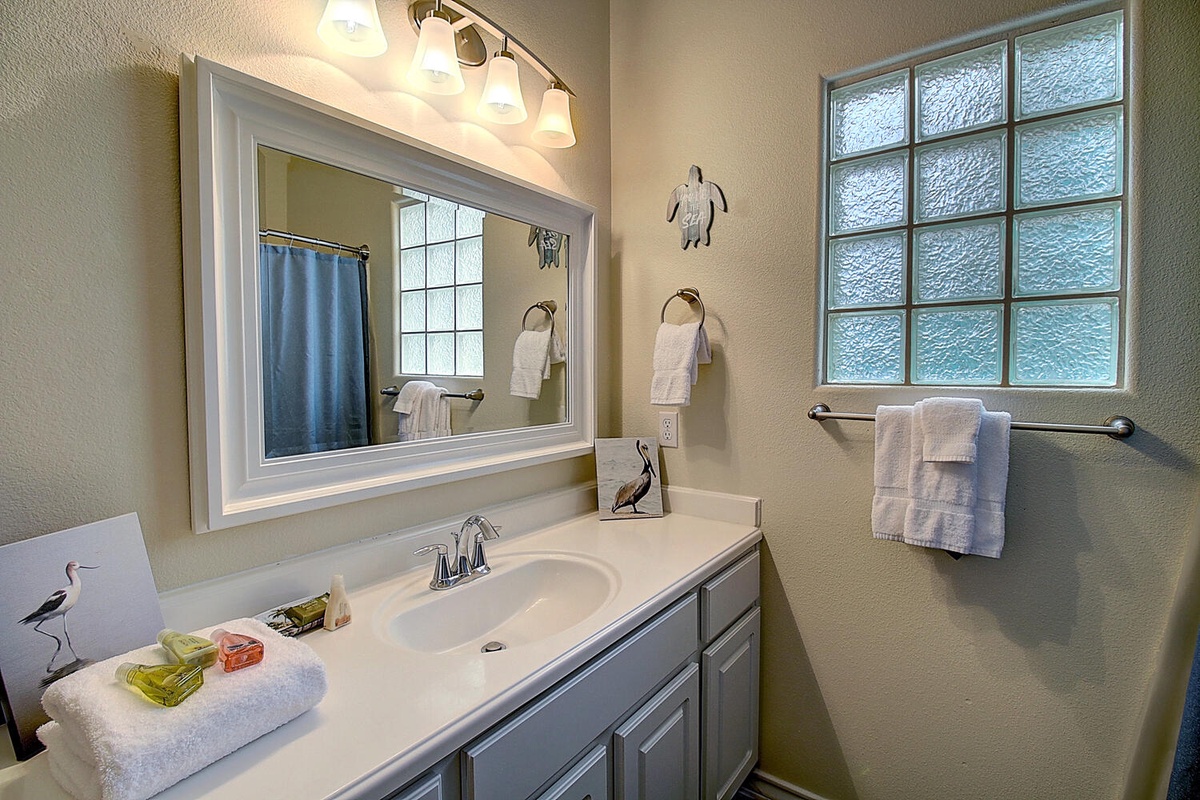 Your private bathroom offers a peaceful retreat with polished fixtures, fresh towels, and thoughtful lighting—perfect for unwinding after exploring.