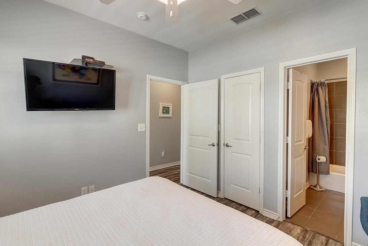 Unwind in your peaceful bedroom with a wall-mounted TV and ensuite bathroom, designed for comfort and convenience.