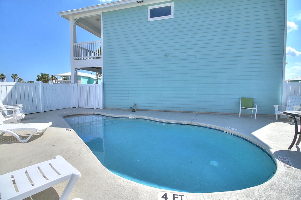 Dive into your own private pool surrounded by comfortable loungers and coastal charm.