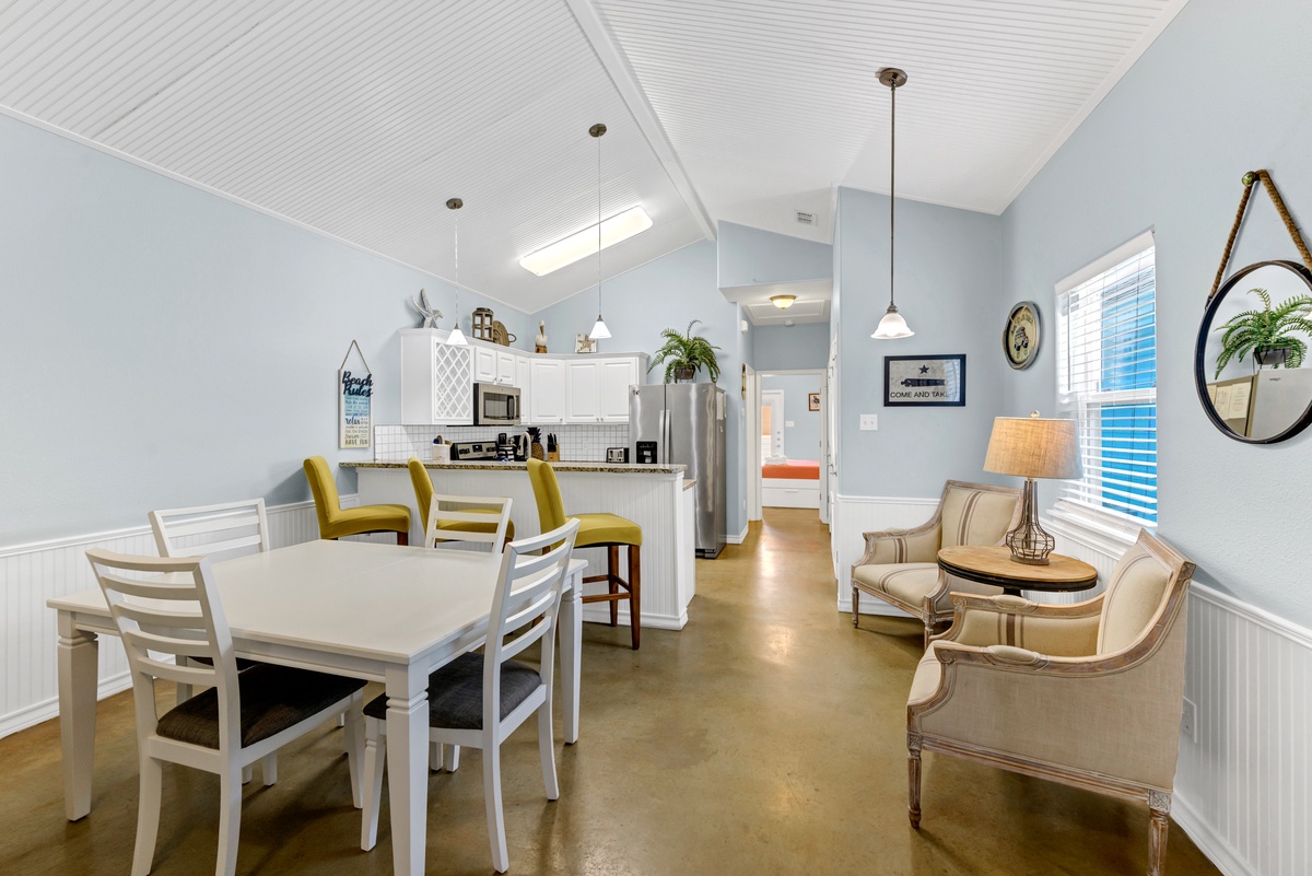Your bright, open-concept space blends modern comfort with coastal charm, featuring vaulted ceilings and stylish furnishings perfect for relaxing together.