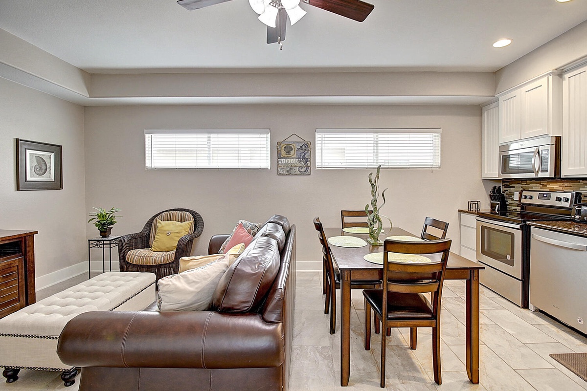 Your open-concept retreat blends living and dining with warm wood tones, leather comfort, and a fully-equipped kitchen for memorable meals.